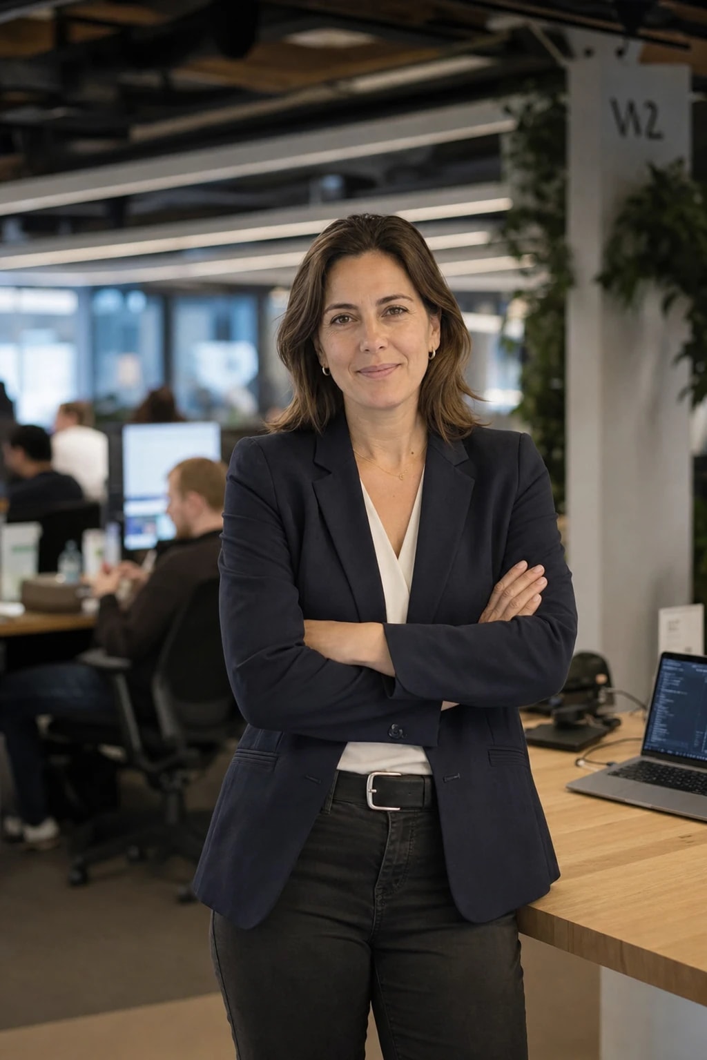 DSI / CTO at their desk in a modern open-plan tech office — the kind of person who validates Vonbuild's security architecture